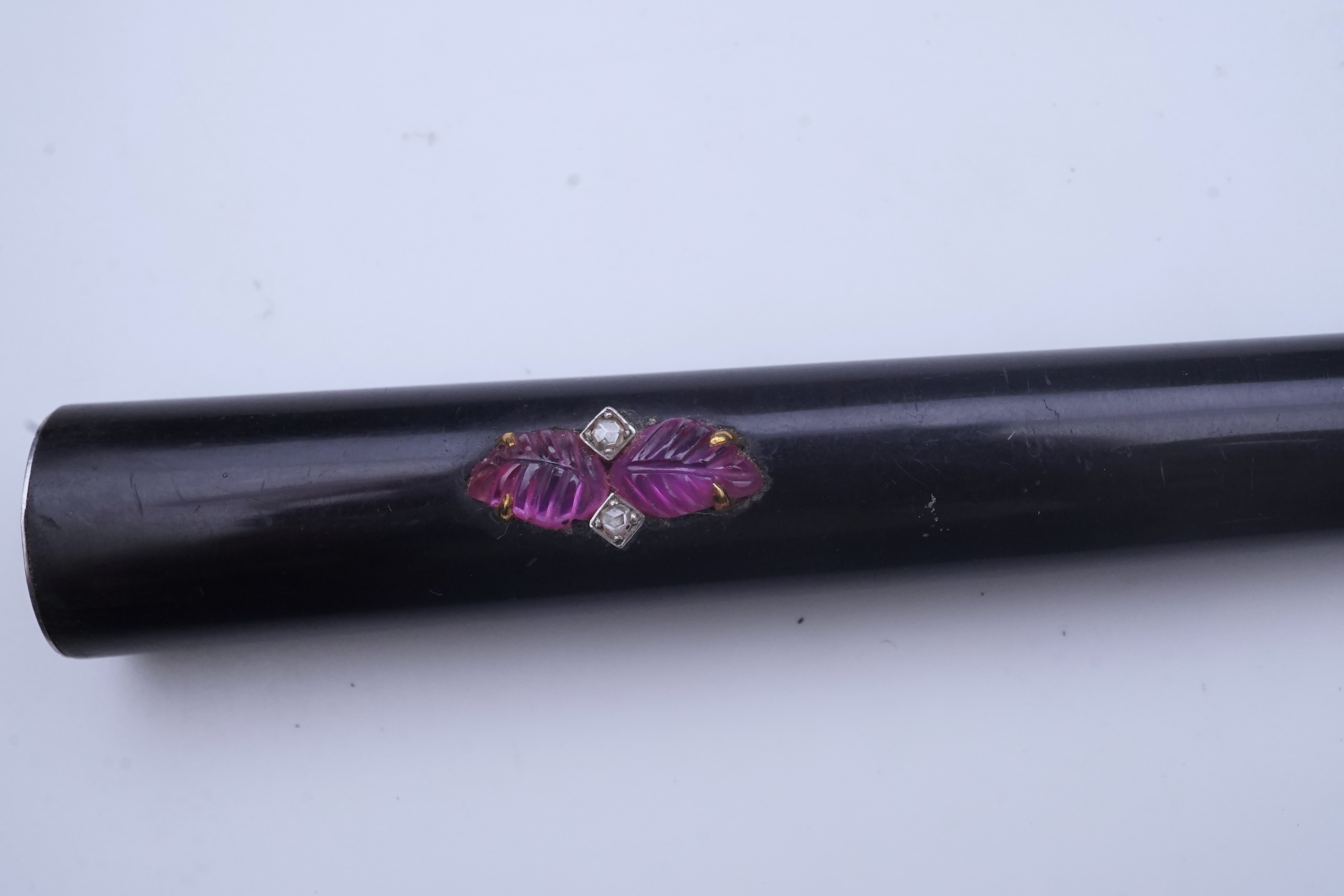 Cartier, an Art Deco tortoiseshell, ruby and diamond cigarette holder, 1920s